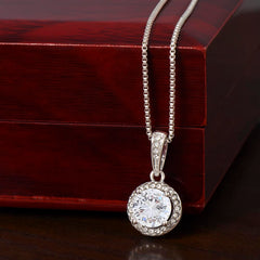  
Close-up of the Eternal Hope white gold solitaire necklace pendant resting against a mahogany-style LED luxury box.