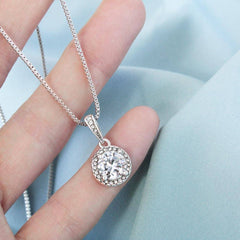Hand holding the sparkling Eternal Hope cushion cut necklace pendant to show its true size and brilliance.